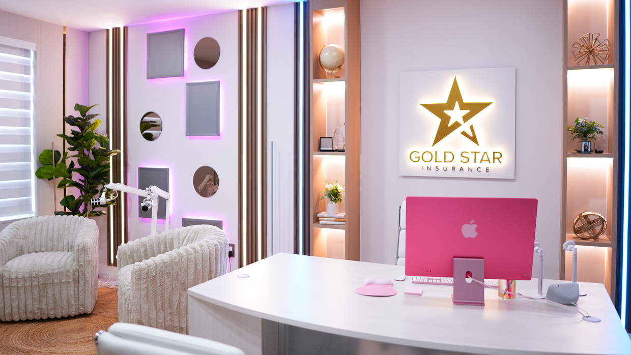 Reception area at the Gold Star Insurance office, with the logo lit up on the wall